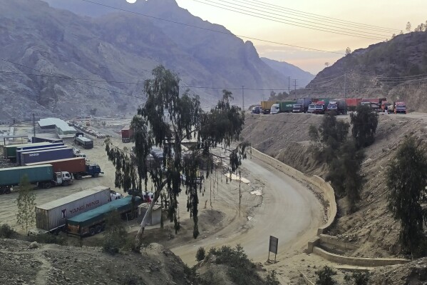 FILE - Stranded trucks loaded with supplies for Afghanistan, park in a terminal along side on a highway after Afghan Taliban rulers closed a key border crossing point Torkham, in Landi Kotal, an area in Pakistan's district Khyber along the Afghan border, Tuesday, Feb. 21, 2023. Pakistani authorities closed the key border crossing with landlocked Afghanistan on Wednesday, Sept. 6, 2023, shortly after border guards from the two sides exchanged fire, officials and residents said, in a sign of increasing tensions between the two neighbors. (AP Photo/Qazi Rauf, File)