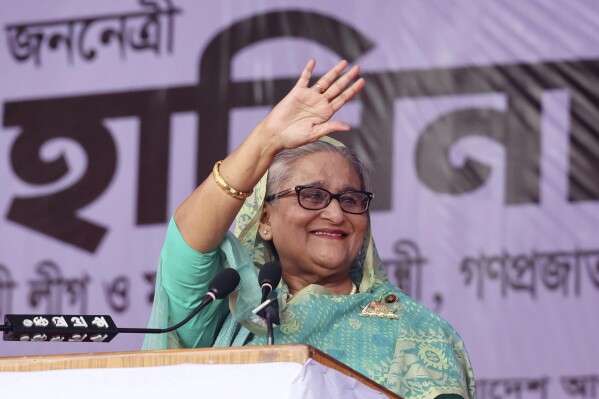 Bangladesh's Prime Minister Sheikh Hasina waves to the gathering during an election campaign rally for her ruling Awami League party, ahead of the upcoming national elections, in Sylhet, Bangladesh, Wednesday, Dec. 20, 2023. The country is gearing up for the Jan. 7 election, but opposition Bangladesh Nationalist Party led by former Prime Minister Khaleda Zia repeated its call on Wednesday to boycott the election. (AP Photo/Saiful Islam Kallal)