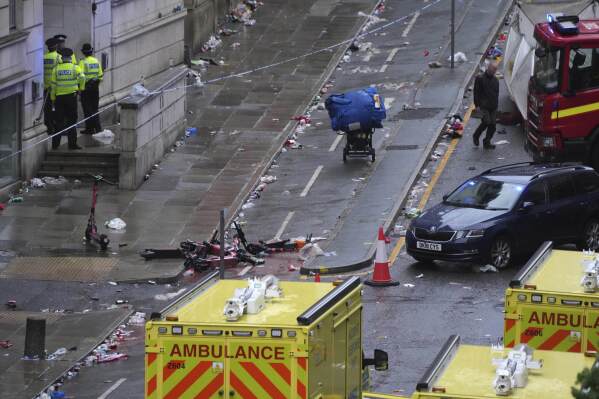 Police and emergency personnel deal with an incident after a car collided with pedestrians near the Liver Building during the Premier League winners parade in Liverpool, England, Monday, May 26, 2025.(AP Photo/Jon Super)