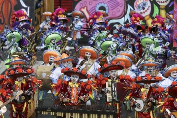 FILE- Members of the South Philadelphia String Band perform during the 116th annual Mummers Parade in Philadelphia on Jan. 1, 2016. The outdoor portion of Philadelphia’s famous and sometimes inflammatory New Year’s Day parade featuring the Mummers has been pushed to Sunday, Jan. 2, 2022, because of rain in the forecast. The indoor portion of the events that includes performances at the Pennsylvania Convention Center will still continue as planned on Saturday, Jan. 1. (AP Photo/Joseph Kaczmarek, File)