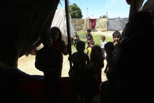 Syrian children play in a refugee camp near Amman, Jordan, on Monday, June 5, 2023. (AP Photo/Raad Adayleh)