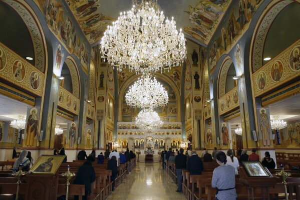 FILE - Christian worshippers take part in Sunday Mass at the Saint Nicolas Church in Beirut, Lebanon, Sunday, May 10, 2020. In the Middle East and North Africa, where religion is often ingrained in daily life's very fabric, rejecting faith can come with social or other repercussions, so many of the "nones," a group that includes agnostics, atheists and "nothing in particular" conceal that part of themselves, as blasphemy laws and policies are widespread in the region. (AP Photo/Bilal Hussein, File)