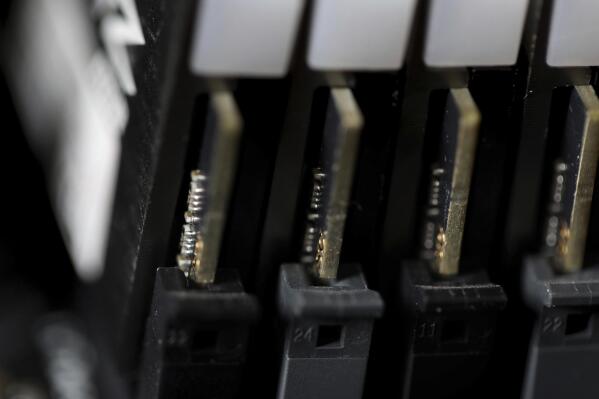 FILE - This Feb 23, 2019, file photo shows the inside of a computer in Jersey City, N.J. The Biden administration will offer rewards up to $10 million for information leading to the identification of foreign state-sanctioned malicious cyber activity against critical U.S. infrastructure, including ransomware attacks. The administration is launching the website stopransomware.gov to offer the public resources for countering the threat. (AP Photo/Jenny Kane, File)