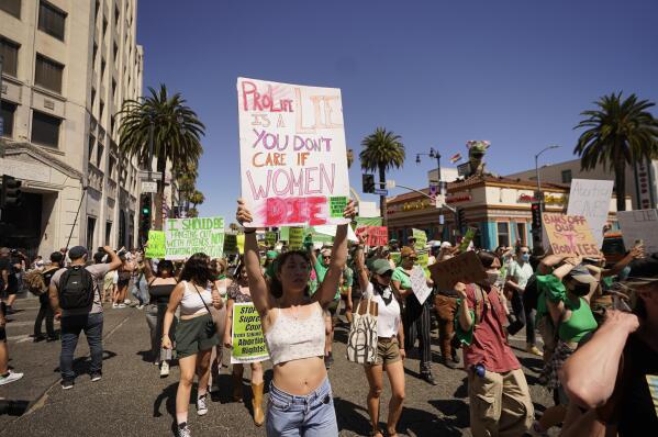 FILE - Abortion-rights activists rally on Hollywood Boulevard in Los Angeles, Saturday, July 9, 2022. Gov. Gavin Newsom signed more than a dozen new abortion laws on Tuesday, Sept. 27, 2022, including some that deliberately clash with restrictions in other states. (AP Photo/Damian Dovarganes, File)