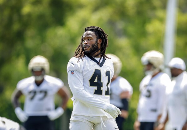 New Orleans Saints running back Alvin Kamara (41) takes off his helmet during the team's NFL mini-camp football practice at Ochsner Sports Performance Center in Metairie, La., Tuesday, June 11, 2024. (Sophia Germer/The Times-Picayune/The New Orleans Advocate via AP)