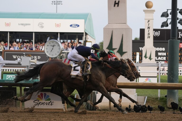 Sierra Leone (2) with jockey Tyler Cafalione, Forever Young with jockey Ryuji Sakai and Mystic Don with jockey Brian Hernandez Jr. cross the finish line during the 150th running of the Kentucky Derby horse race, Saturday, May 4, 2024, at Churchill Downs.  , in Louisville, Ky.  (AP Photo/Kichiro Sato)