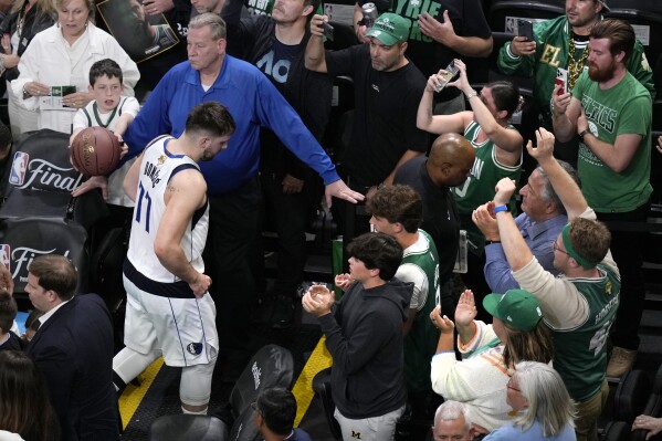 Dallas Mavericks guard Luka Doncic (77) heads to the locker room after a 105-98 loss to the Boston Celtics following Game 2 of the NBA Finals basketball series, Sunday, June 9, 2024, in Boston. (AP Photo/Michael Dwyer)