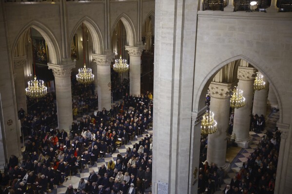 Guests attend an inaugural Mass, with the consecration of the high altar, at the Notre-Dame de Paris Cathedral, five-and-a-half years after a fire ravaged the Gothic masterpiece, as part of ceremonies to mark the Cathedral's reopening after its restoration, in Paris, France, Sunday, Dec. 8, 2024. (Sarah Meyssonnier/Pool Photo via AP)