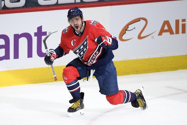 FILE - Washington Capitals left wing Alex Ovechkin celebrates scoring his 718 career goal during the second period of the team's NHL hockey game against the New York Islanders in Washington, in this Tuesday, March 16, 2021, file photo. Ovechkin re-signed with the Washington Capitals on the eve of free agency, Tuesday, July 27, 2021, inking a four-year deal worth $40 million.(AP Photo/Nick Wass, File)