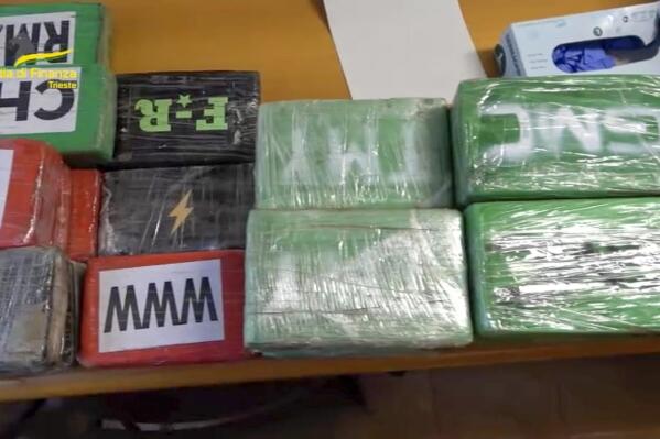 This picture taken from a video released on Tuesday, June 7, 2022, by the Italian Financial Police during a press conference in Trieste, northern Italy, shows piles of seized cocaine as part of an international investigation that has dealt a blow to the feared Colombian Gulf Clan in one of the largest drug busts ever in Europe. (Guardia di Finanza via AP)