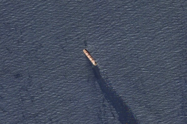 In this satellite image provided by Planet Labs, the Belize-flagged bulk carrier Rubymar is seen leaking oil in the southern Red Sea near the Bay al-Mandeb Strait after an attack by Yemen's Houthi rebels on Tuesday, Feb. 20, 2024 Is.  Despite a month of US-led airstrikes, Yemen's Iran-backed Houthi rebels have been able to launch significant attacks.  This week, they seriously damaged a ship in a key strait and apparently shot down an American drone worth millions of dollars.  (Planet Labs PBC via AP)