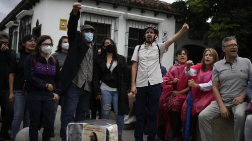 People gather outside the Constitutional Court where a session to examine the complaints of several political parties about irregularities in the June 25th general elections is underway, in Guatemala City, Saturday, July 1, 2023. (AP Photo/Moises Castillo)