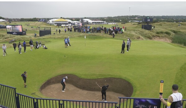 South Africa's Christiaan Bezuidenhout, bottom right plays out of a bunker on the 17th hole during a practice round for the British Open Golf Championships at the Royal Liverpool Golf Club in Hoylake, England, Tuesday, July 18, 2023. The Open starts Thursday, July 20. (AP Photo/Kin Cheung)