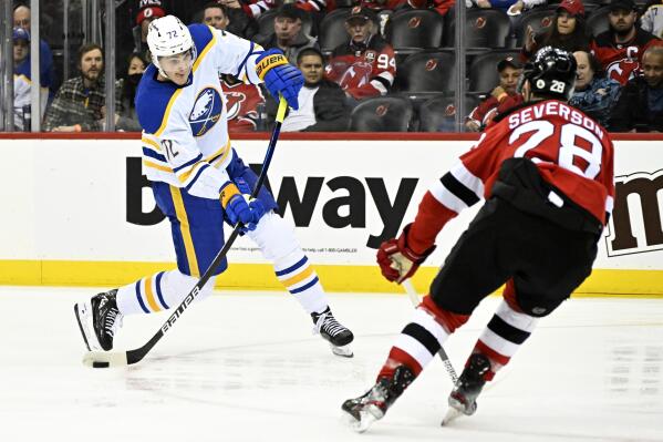 Buffalo Sabres right wing Tage Thompson (72) shoots as New Jersey Devils defenseman Damon Severson (28) defends during the second period of an NHL hockey game Thursday, April 21, 2022, in Newark, N.J. (AP Photo/Bill Kostroun)