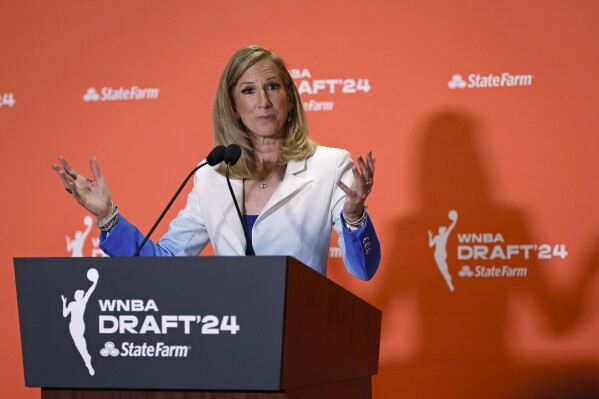 FILE - WNBA Commissioner Cathy Engelbert speaks before the WNBA basketball draft April 15, 2024, in New York. The WNBA will use league-wide charter flights for the first time this season, the league announced Thursday, May 9. The charters will begin at the start of the regular season. “We are thrilled to announce the launch of a full charter program as soon as practical for the 2024 and 2025 seasons, a testament to the continued growth of the WNBA,” Engelbert said in a statement. (AP Photo/Adam Hunger, File)