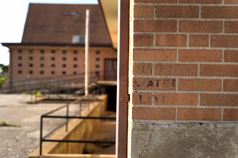 A faded water line marking the height of the 1973 flood is visible on the wall of a damaged and vacant church Wednesday, May 22, 2024, in West Alton, Mo. Devastating flooding, driven in part by climate change, is taking an especially damaging toll on communities that once thrived along the banks of the Mississippi River. (AP Photo/Jeff Roberson)