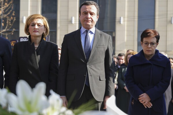 Mimoza Kusari-Lila, left, head of Vetevendosje! Parliamentary group, Kosovo's Prime Minister Albin Kurti, and Donika Gervalla-Schwarz, Kosovo's Foreign Minister, stand at Mother Teresa's square in Pristina, Kosovo, Monday, Feb. 10, 2025. (AP Photo/Vlasov Sulaj)