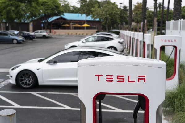 File - Tesla electric vehicles are charged at a charging station in Anaheim, Calif., June 9, 2023. (AP Photo/Jae C. Hong, File)