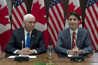 Canadian Prime Minister Justin Trudeau, right, and U.S. Vice President Mike Pence wait for the Canadian Council for the United States–Mexico–Canada Agreement meeting to begin on Parliament Hill in Ottawa, Ontario, Thursday, May 30, 2019. (Adrian Wyld/The Canadian Press via AP)