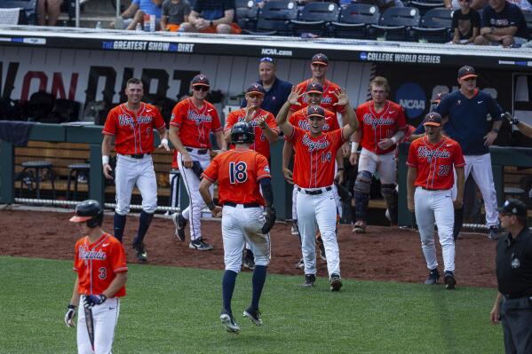 Virginia's Zach Gelof (18) celebrates his run with teammates in the seventh inning against Tennessee during a baseball game in the College World Series, Sunday, June 20, 2021, at TD Ameritrade Park in Omaha, Neb. (AP Photo/John Peterson)