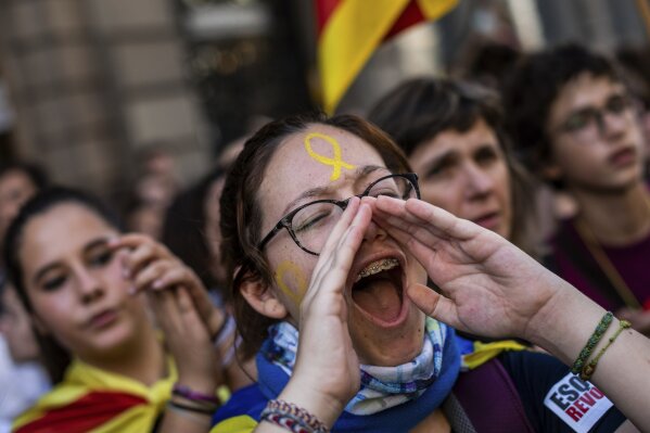Students protest in Barcelona, Spain, Thursday, Oct. 17, 2019. Catalonia's separatist leader vowed Thursday to hold a new vote to secede from Spain in less than two years as the embattled northeastern region grapples with a wave of violence that has tarnished a movement proud of its peaceful activism. Thousands of people have also been marching peacefully since Wednesday toward the regional capital, Barcelona. Students are on strike, and trade unions are planning to join them on Friday. (AP Photo/Bernat Armangue)