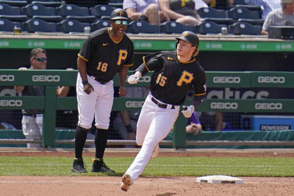 Pittsburgh Pirates' Jack Suwinski (65) rounds first past first base coach Tarrik Brock after hitting a three-run home run off Colorado Rockies relief pitcher Carlos Estevez (54) during the sixth inning of a baseball game in Pittsburgh, Wednesday, May 25, 2022. The Pirates won 10-5. (AP Photo/Gene J. Puskar)