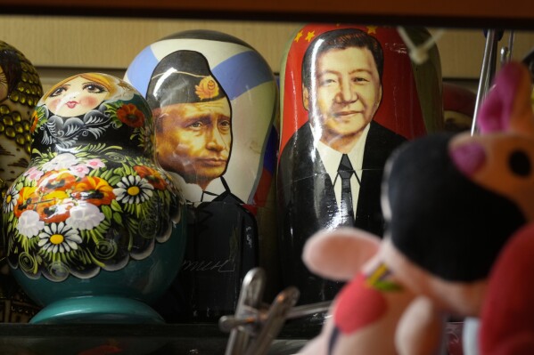 Traditional Russian wooden dolls called Matryoshka depicting Russian President Vladimir Putin and China's President Xi Jinping are displayed for sale at a souvenir shop in St. Petersburg, Russia, Monday, Feb. 24, 2025. (AP Photo/Dmitri Lovetsky)