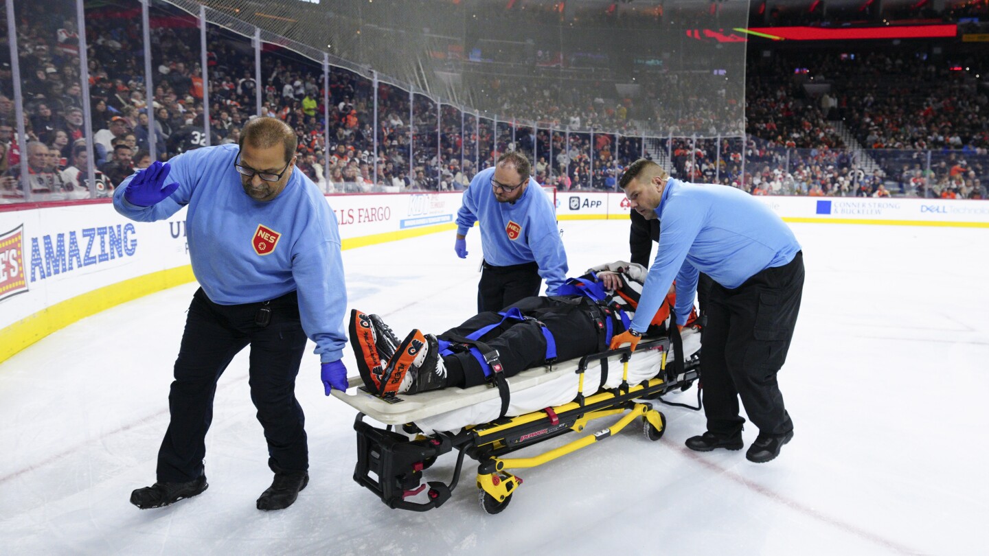 NextImg:NHL referee Mitch Dunning communicative, can move extremities following violent collision