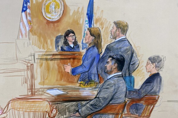 This artist sketch depicts Judge Dipti Pidikiti-Smith of the Fairfax County General District Court, presiding over the assault and battery trial of CIA officer trainee Ashkan Bayatpour, seated left, in Fairfax, Va., Wednesday, Aug. 23, 2023. Standing in front of the judge are the prosecutor, Deputy Commonwealth's Attorney Jenna Sands, left, and Bayatpour's defense lawyer Stuart A. Sears, right. The judge found Bayatpour guilty Wednesday of attacking a fellow CIA trainee with a scarf in the stairwell of CIA headquarters at Langley last year. Seated right is an unidentified defense team member. (Dana Verkouteren via AP)
