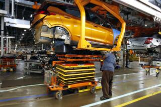 FILE - A battery is lifted into place for installation in the Chevrolet Bolt EV at the General Motors Orion Assembly plant, Nov. 4, 2016, in Orion Township, Mich. Michigan would create new economic development funds to help the state land major business expansions, including possible electric vehicle and battery plants, under fast-tracked bills that received initial approval Wednesday, Dec. 8, 2021. (AP Photo/Duane Burleson, File)
