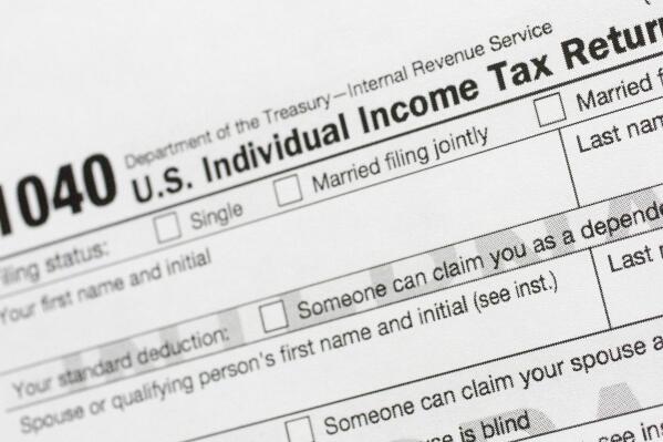 FILE - A portion of the 1040 U.S. Individual Income Tax Return form is shown July 24, 2018, in New York. The IRS has been tasked with looking into how to create a government-operated electronic free-file tax return system for all. Congress has directed the IRS to report in on how such a system might work. (AP Photo/Mark Lennihan, File)