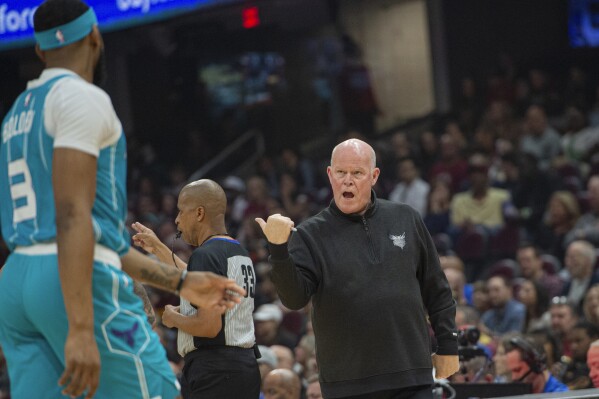 Charlotte Hornets head coach Steve Clifford, right, talks with Marques Bolden (3) during the first half of an NBA basketball game against the Cleveland Cavaliers in Cleveland, Sunday, April 14, 2024. (AP Photo/Phil Long)