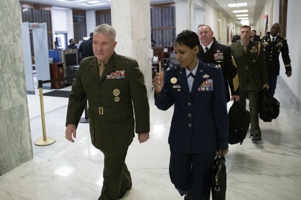 U.S. Marine Corps Gen. Kenneth McKenzie, Jr., Commander, U.S. Central Command, left, walks to a House Armed Services hearing, on Capitol Hill, Tuesday, March 10, 2020, in Washington. (AP Photo/Alex Brandon)