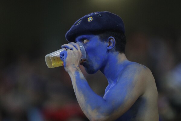 A French fan drinks a beer during the Rugby World Cup Pool A match between France and Uruguay at the Pierre Mauroy stadium in Villeneuve-d'Ascq, outside Lille, France, Thursday, Sept. 14, 2023. (AP Photo/Michel Spingler)
