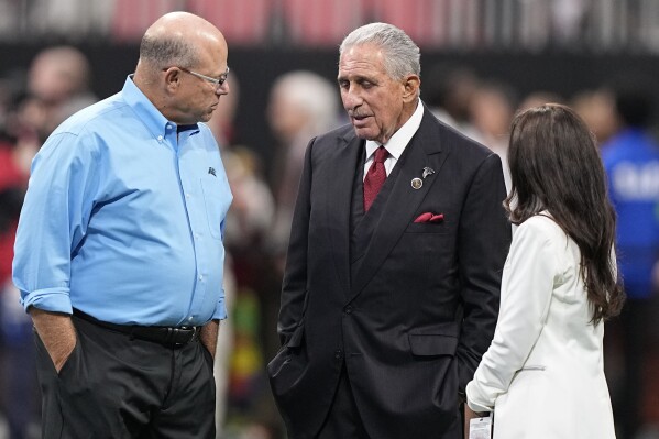 Carolina Panthers Owner David Tepper, left, and Atlanta Falcons Owner Arthur Blank speak before the first half of an NFL football game, Sunday, Sept. 10, 2023, in Atlanta. (AP Photo/Brynn Anderson)