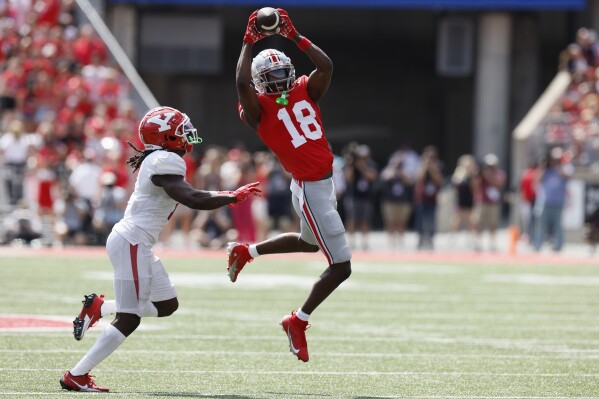 Ohio State receiver Marvin Harrison, right, catches the ball in front of Youngstown State defensive back D'Marco Augustin during the first half of an NCAA college football game Saturday, Sept. 9, 2023, in Columbus, Ohio. (AP Photo/Jay LaPrete)