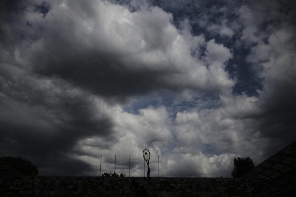 Australia's Daria Kasatkina is silhouetted as she plays Spain's Paula Badosa during their third round match of the French Tennis Open, at the Roland-Garros stadium, in Paris, Saturday, May 31, 2025. (AP Photo/Christophe Ena)