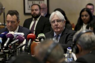FILE - In this Feb. 5, 2019 file photo, United Nations Special Envoy to Yemen Martin Griffiths, center, and President of the International Committee of the Red Cross Peter Maurer, speak during a new round of talks by Yemen's warring parties in Amman, Jordan.  Yemen’s warring sides on Friday, Sept. 18, 2020,  started U.N.-brokered peace consultations in Switzerland to exchange prisoners, the United Nations said, part of a long-delayed deal aiming to end a conflict that has killed thousands of civilians and set off the world’s worst humanitarian crisis. (AP Photo/Raad Adayleh)