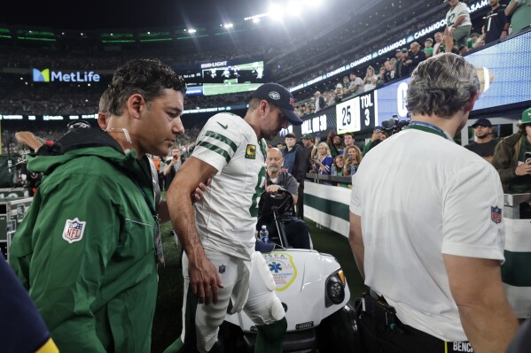 FILE - New York Jets quarterback Aaron Rodgers (8) is helped off the field after getting injured during the first quarter of an NFL football game against the Buffalo Bills, Monday, Sept. 11, 2023, in East Rutherford, N.J. Rodgers has a torn left Achilles tendon and the 39-year-old New York Jets quarterback will miss the rest of the season, coach Robert Saleh announced Tuesday. (AP Photo/Adam Hunger, File)