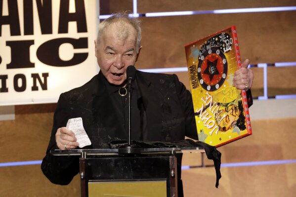 FILE - This Sept. 11, 2019 file photo shows John Prine accepting the Album of the Year award at the Americana Honors & Awards show in Nashville, Tenn. The Recording Academy has released a new recording of John Prine’s “Angel From Montgomery” with proceeds going to support the MusiCares COVID-19 Relief Fund. Prine died in April at age 73 from complications associated with the new coronavirus. (AP Photo/Wade Payne, File)