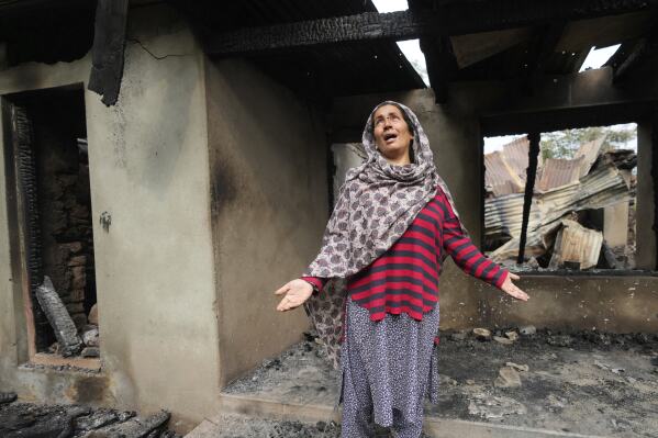 Rubina Begum wails as she stands outside her house damaged by Pakistani artillery shelling, at Salamabad village in Uri ,north of Srinagar, Indian controlled Kashmir, Thursday, May 8, 2025. (AP Photo/Mukhtar Khan)