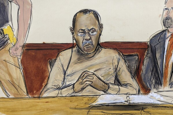 In this courtroom sketch Mozambique's former finance minister Manuel Chang, center, pleaded not guilty in a U.S. federal court, in New York, Thursday, July 13, 2023, in connection with a $2-billion corruption and money laundering scandal that prosecutors said defrauded American investors and threatened to further destabilize the economy of one of the world's poorest countries. (Elizabeth Williams via AP)