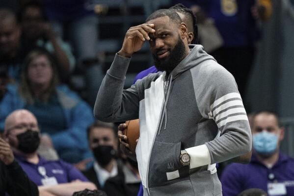 Los Angeles Lakers forward LeBron James looks on during the first half of an NBA basketball game against the Charlotte Hornets in Charlotte, N.C., Friday, Jan. 28, 2022. (AP Photo/Jacob Kupferman)