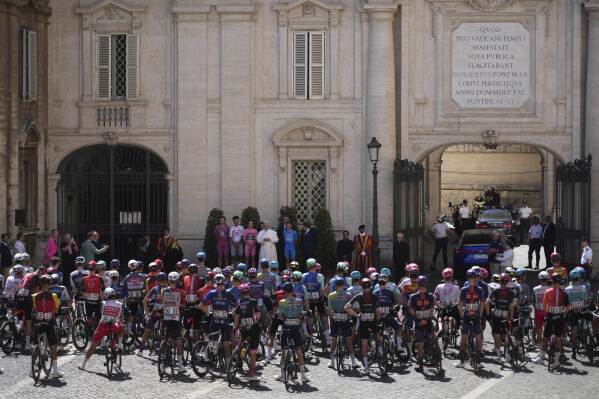 Flanked by race leaders, from left, Denmark's Mads Pedersen, Mexico's Isaac Del Toro, Britain's Simon Yates and Italy's Lorenzo Fortunato, Pope Leo XIV blesses the pack before the start of the final stage of the Giro d'Italia, at the Vatican, Sunday, June 1, 2025. (AP Photo/Andrew Medichini)