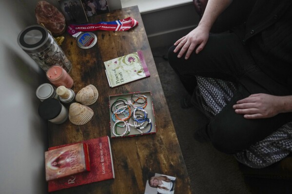 Ashton Colby's meditation corner has meaningful objects, including an image before he transitioned, in his apartment in Columbus, Ohio, on Thursday, Jan. 18, 2024. (AP Photo/Carolyn Kaster)