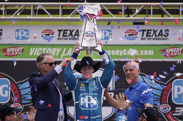 Josef Newgarden, center, celebrates winning the IndyCar auto race at Texas Motor Speedway in Fort Worth, Texas, Sunday, April 2, 2023. (AP Photo/LM Otero)