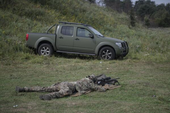 Ukrainian sniper Andriy attends a training outside of Kyiv, Ukraine, Saturday Aug. 27, 2022. After moving to Western Europe to work an an engineer, Andriy scrambled back to Ukraine at the start of the war, and within weeks underwent a conversion from civilian life to a sniper being trained by the country's special forces. (AP Photo/Andrew Kravchenko)