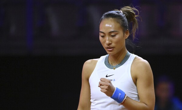 China's Qinwen Zheng raises a fist during the Porsche Tennis Grand Prix WTA tennis tournament in Stuttgart, Germany, Tuesday, April 16, 2024. (Marijan Murat/dpa via AP)