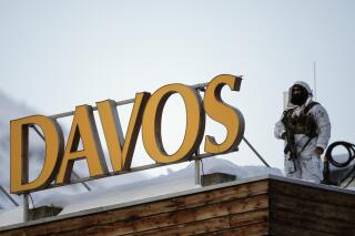 File---File picture taken Jan.24, 2022 shows a police security guard on the roof of a hotel ahead of the World Economic Forum in Davos, Switzerland. (AP Photo/Markus Schreiber,file)