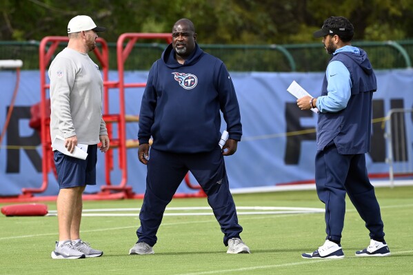Tennessee Titans defensive line coach Terrell Williams, center, talks with coaches during an NFL football training camp practice Tuesday, Aug. 8, 2023, in Nashville, Tenn. Mike Vrabel announced Monday that Terrell Williams will be Tennessee's acting head coach Saturday during the Titans' preseason opener in Chicago. (Mark Zaleski/The Tennessean via AP)